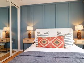 A bedroom with a bed and bedside table at 8 Karn Havos St. Eval near Mawgan Porth