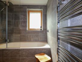 A bathroom with a bathtub and a window at 8 Karn Havos, St. Eval near Mawgan Porth