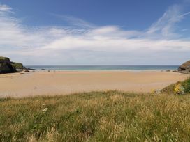 A beach with sand and sea at 8 Karn Havos St. Eval near Mawgan Porth