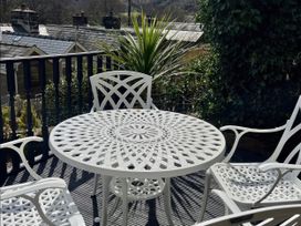 An outdoor seating area with a table and chairs at Copper Miners Cottage, Beddgelert, Eryri (snowdonia)