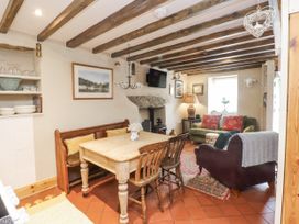 A living room with a table and chairs at Copper Miners Cottage Beddgelert, Eryri (snowdonia)