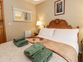 A bedroom with a bed and towels at Copper Miners Cottage Beddgelert, Eryri (snowdonia)