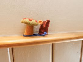 A felt mushroom and a felt mouse on a shelf at Copper Miners Cottage, Beddgelert, Eryri (snowdonia)