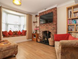 A living room with a fireplace and television at No.64 Nelson St, Bridlington