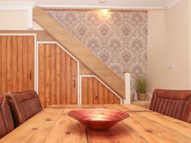 A dining room with a wooden table and decorative bowl at No.64 Nelson St in Bridlington
