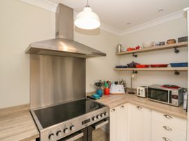A kitchen with a stainless steel cooker and various utensils at No.64 Nelson St in Bridlington