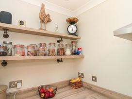 A kitchen with jars on shelves and fruit in a bowl at No.64 Nelson St Bridlington
