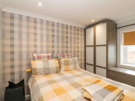 A bedroom with a bed and wardrobe at No.64 Nelson St in Bridlington