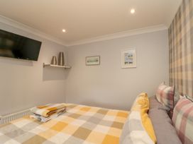 A bedroom with a bed and television at No.64 Nelson St in Bridlington