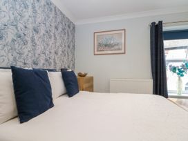 A bedroom with a bed and painting at No.64 Nelson St Bridlington