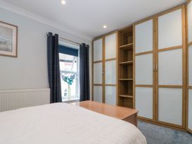 A bedroom with a bed and a wardrobe at No.64 Nelson St in Bridlington
