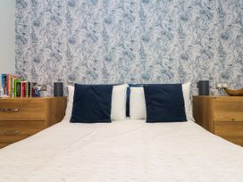 A bedroom with a bed and nightstands at No.64 Nelson St Bridlington
