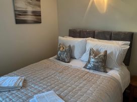 A bedroom with a bed and pillows at Sun House in Allonby