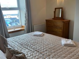 A bedroom with a bed and a dresser at Sun House in Allonby