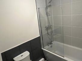 A bathroom with a bathtub and toilet at Sun House in Allonby