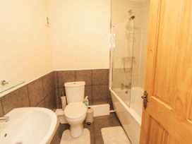 A bathroom with a toilet, sink, and bathtub at Sun House in Allonby