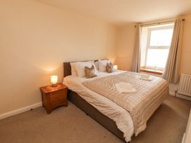 A bedroom with a bed and a window at Sun House in Allonby