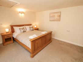 A bedroom with a double bed and bedside tables at Sun House in Allonby