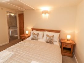 A bedroom with a double bed and nightstands at Sun House in Allonby