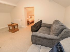 A living room with a sofa and a side table at Sun House in Allonby