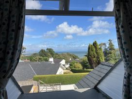 A view of the sea and houses from a window at Swn Y Don in Llanbedrog