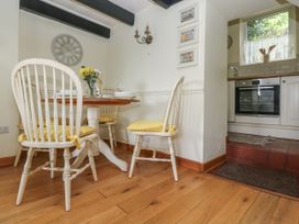 A dining room with a table and chairs at Driftwood Cottage in St. Austell