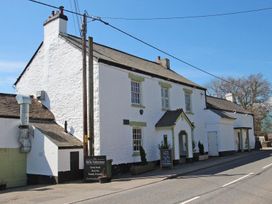 A building with a sign and windows at Valley Lodge 2 in Callington