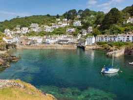 A view of a harbor with houses and a boat at Valley Lodge 2 in Callington