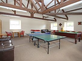 A recreation room with a ping pong table and seating at Valley Lodge 2 Callington