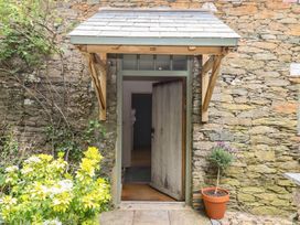 An entrance with a door and plants at Lower Velwell Barn in Totnes