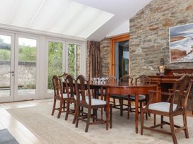 A dining room with a table and chairs at Lower Velwell Barn in Totnes