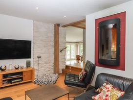 A living room with a television and a sofa at Lower Velwell Barn in Totnes