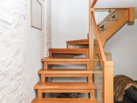 Stairs with wooden steps and railing at Lower Velwell Barn in Totnes