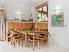 A dining room with a table and chairs at Lower Velwell Barn in Totnes
