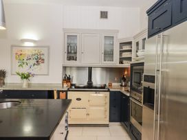A kitchen with an oven and refrigerator at Lower Velwell Barn Totnes