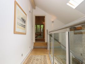 A hallway with stairs and a painting at Lower Velwell Barn in Totnes