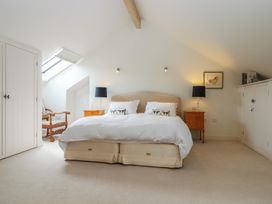 A bedroom with a bed and bedside tables at Lower Velwell Barn in Totnes