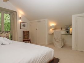 A bedroom with a bed and desk at Lower Velwell Barn in Totnes