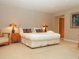 A bedroom with a bed and lamps at Lower Velwell Barn in Totnes