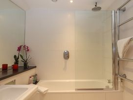 A bathroom with a bathtub and shower at Lower Velwell Barn in Totnes
