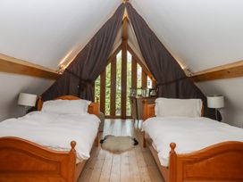 A bedroom with two beds and a view at Lower Velwell Barn in Totnes