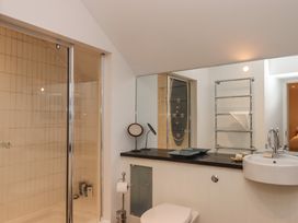 A bathroom with a shower, sink, and toilet at Lower Velwell Barn in Totnes