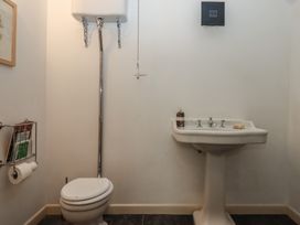 A bathroom with a toilet and sink at Lower Velwell Barn in Totnes