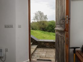 An entryway with a door open to a grassy area at Lower Velwell Barn in Totnes