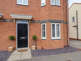The entrance of a house with a black door and planters at 33 Murrayfield Gardens Whitby