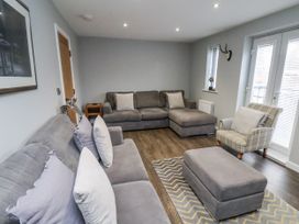 A living room with a couch and ottoman at Pearl Stone House in Whitby