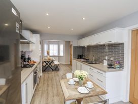 A kitchen with a table and chairs at Pearl Stone House in Whitby