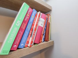 A bookshelf with various cooking books at Pearl Stone House in Whitby