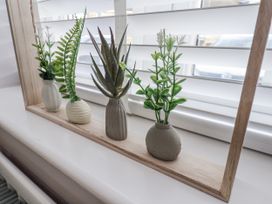 A decorative plant arrangement on a shelf at Pearl Stone House in Whitby