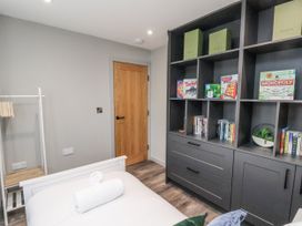 A bedroom with a shelf and a bed at Pearl Stone House in Whitby